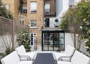 glass box extension on the end of the building, looking in from garden
